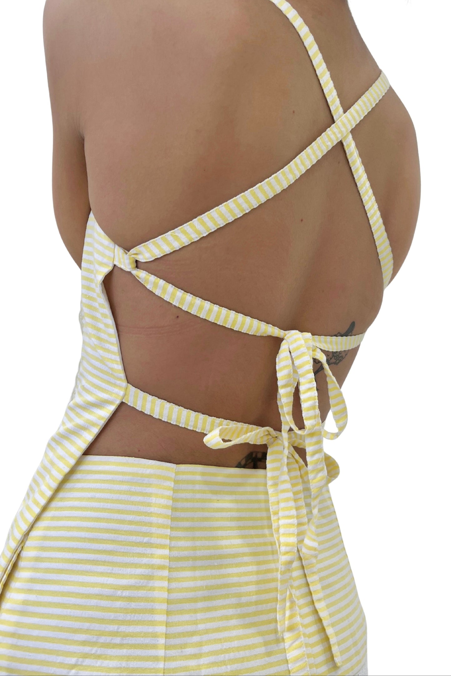 Yellow and white striped strappy with open back on a white background