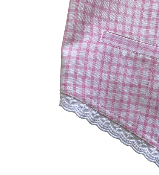 Pink and white checkered fabric with lace trim on a white background