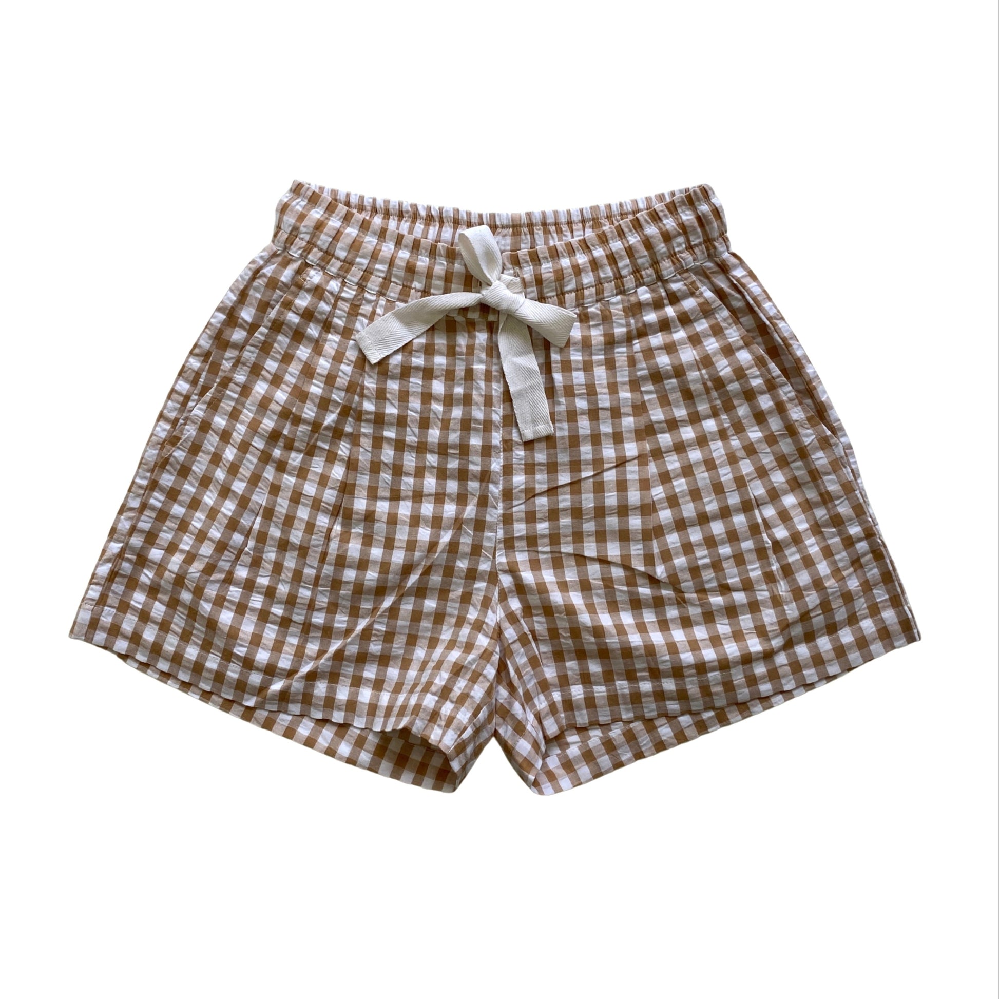 Brown and white checkered shorts with a bow on a white background. Seersucker gingham elasticated shorts with twill tie. Organic Cotton Fabric.