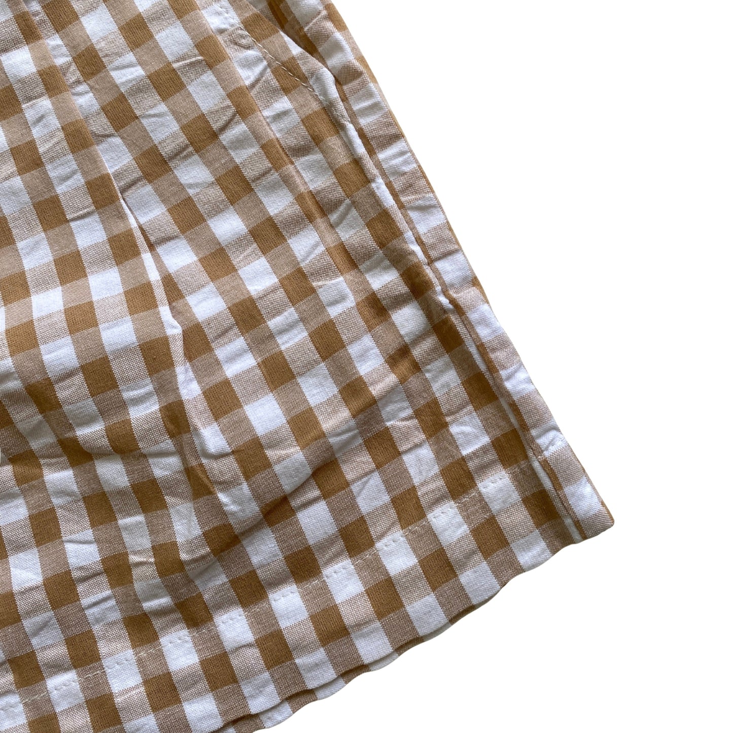 Close-up of a brown and white checkered fabric on a white background