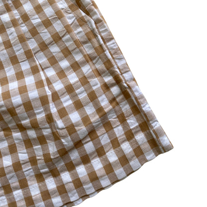 Close-up of a brown and white checkered fabric on a white background