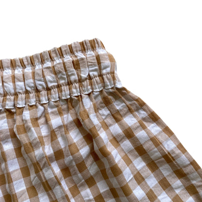 Brown and white checkered shorts on a white background. Elasticated waist. Waistband.