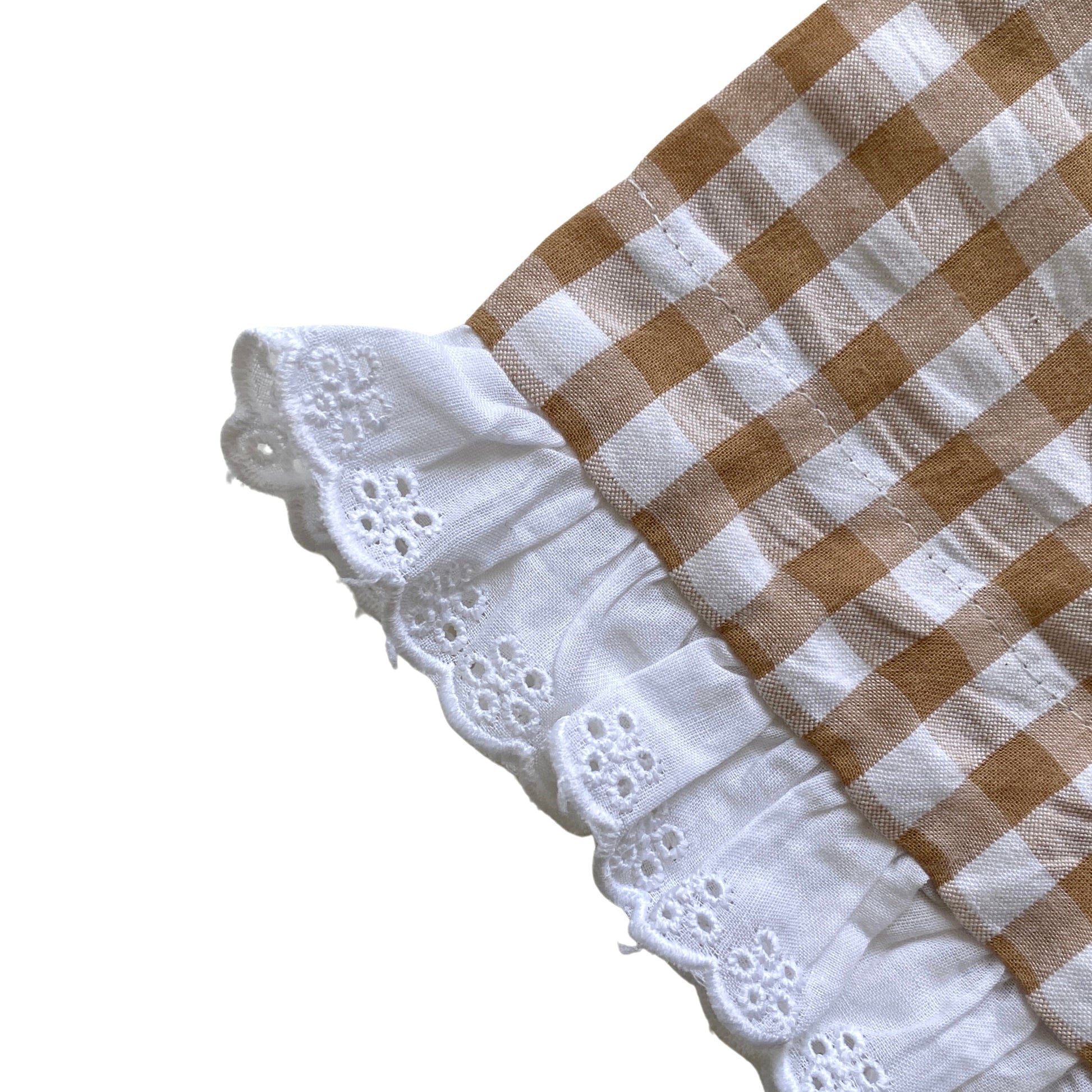Checkered fabric with white lace trim on a white background