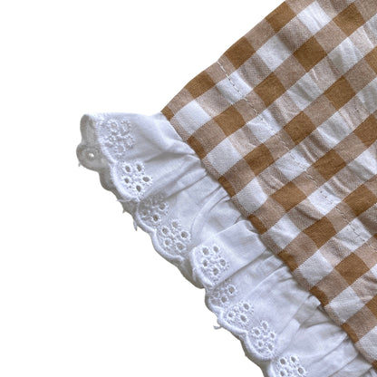 Checkered fabric with white lace trim on a white background