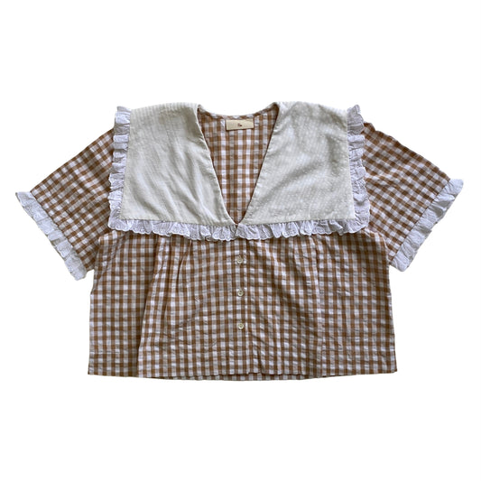 Checkered blouse with ruffled details on a white background. Brown gingham top. gingham blouse. Organic cotton gingham top.
