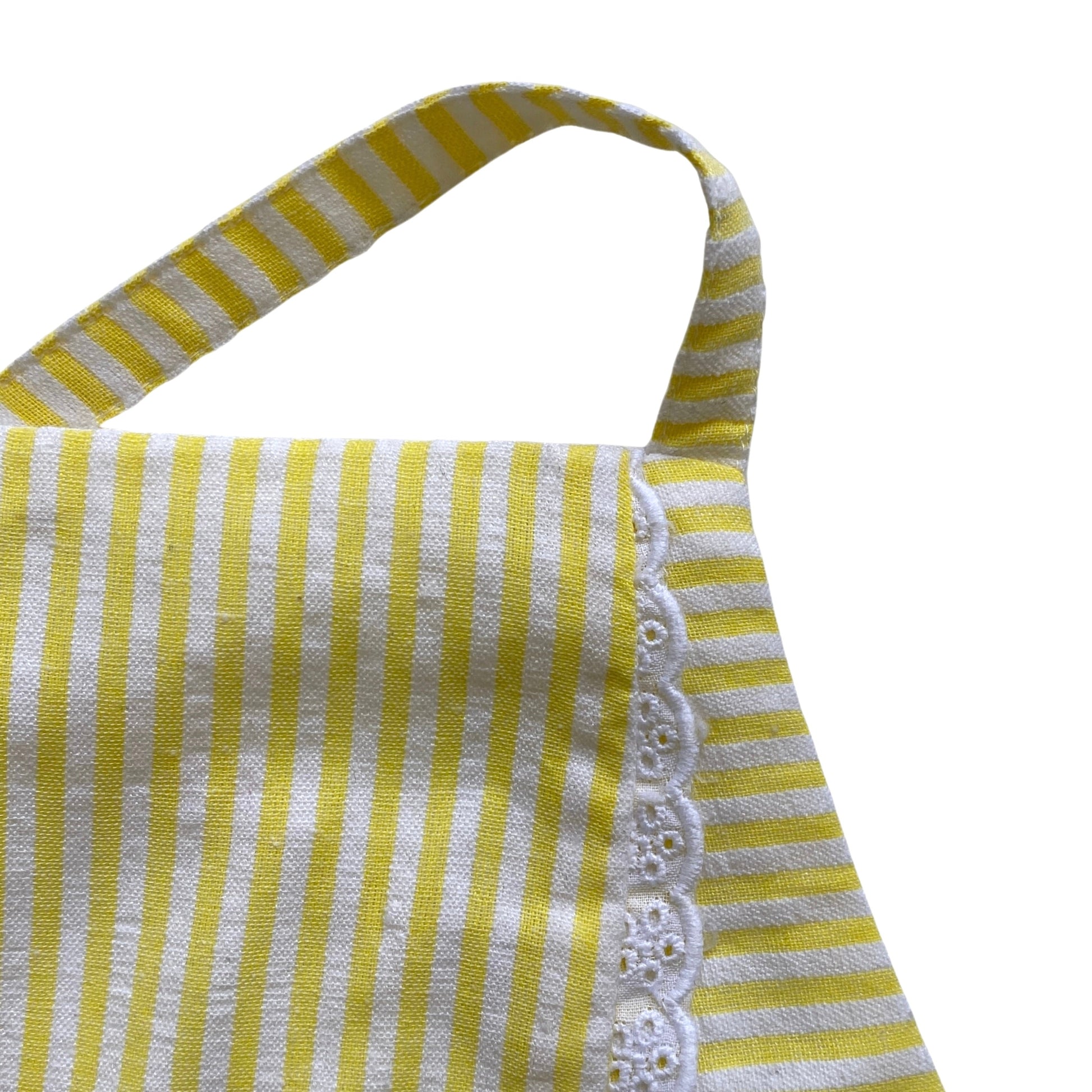 Yellow and white striped apron top with lace trim on a white background
