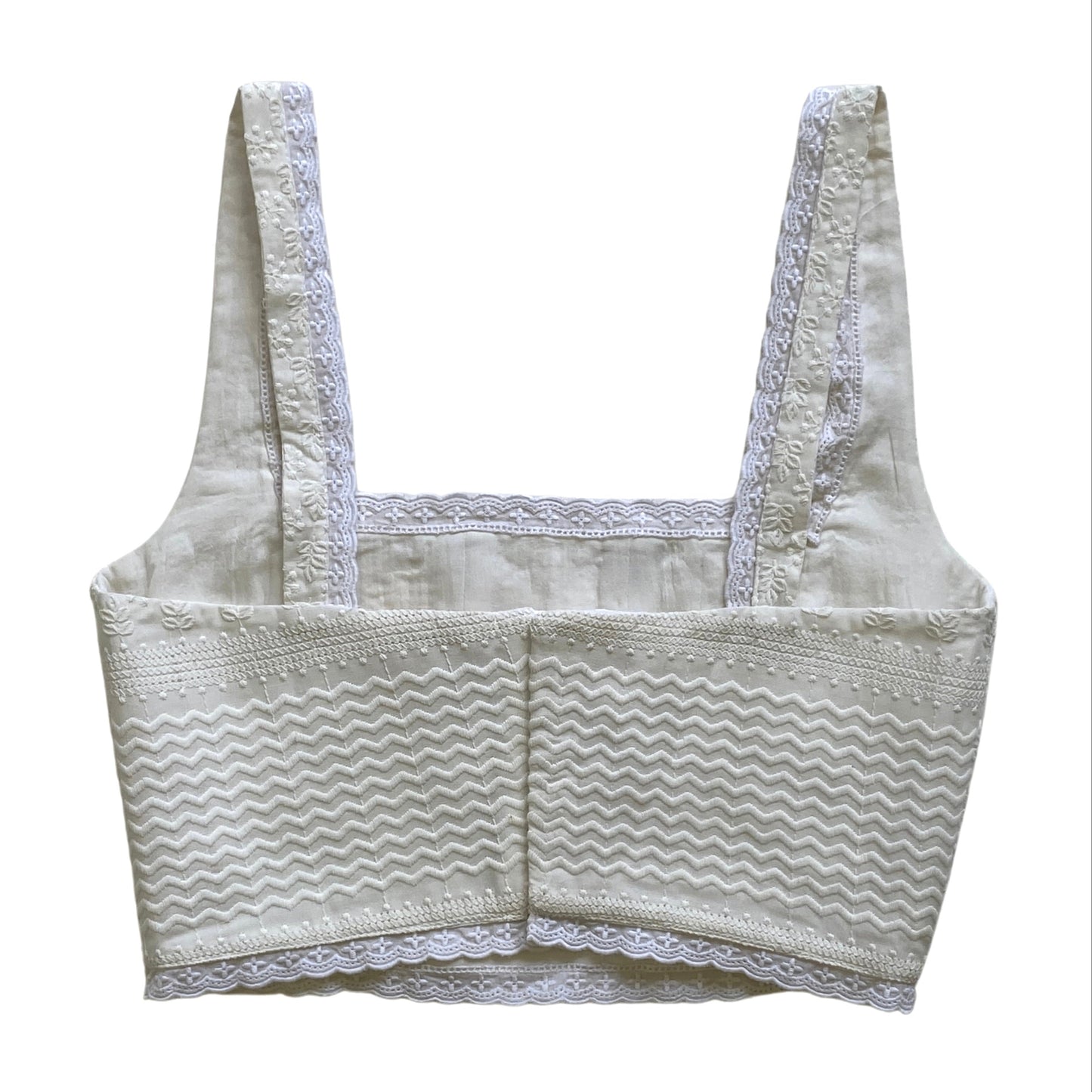 White embroidered lace corset on a white background