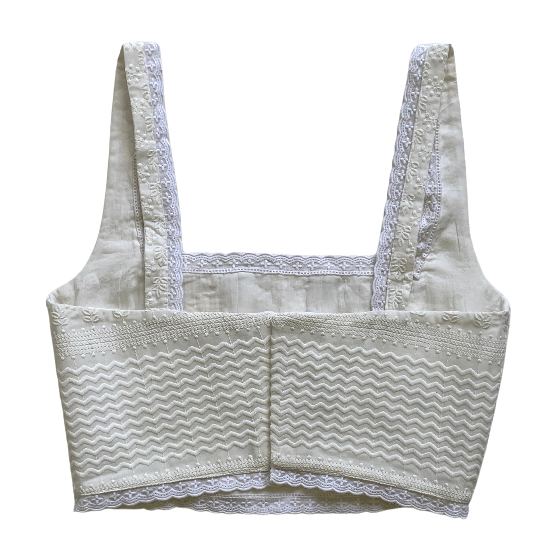 White embroidered lace corset on a white background