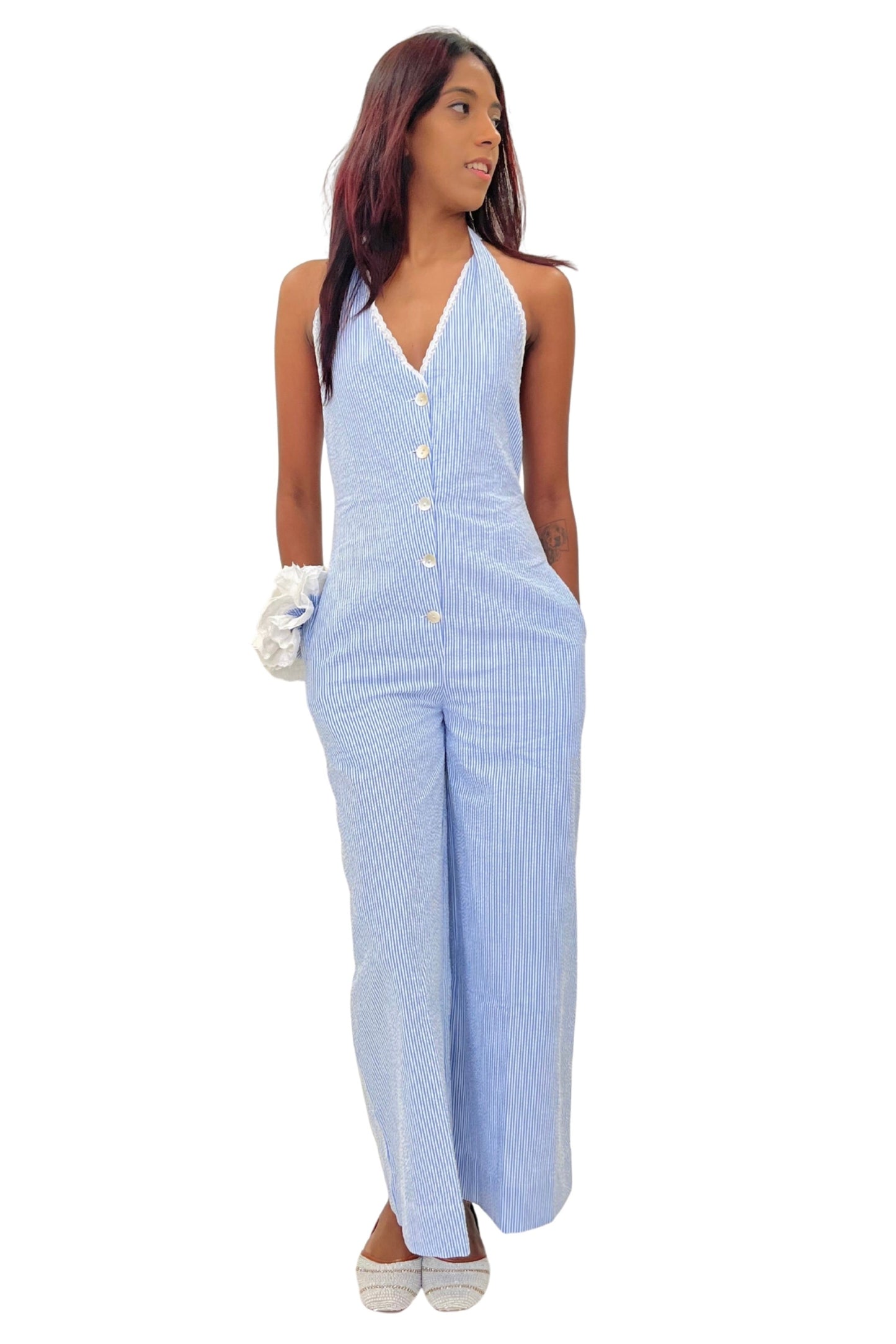 Woman wearing a blue striped jumpsuit on a white background