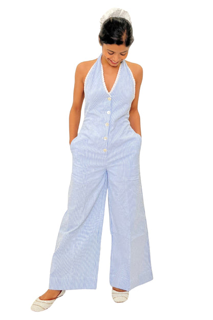 Woman wearing a light blue striped jumpsuit on a white background