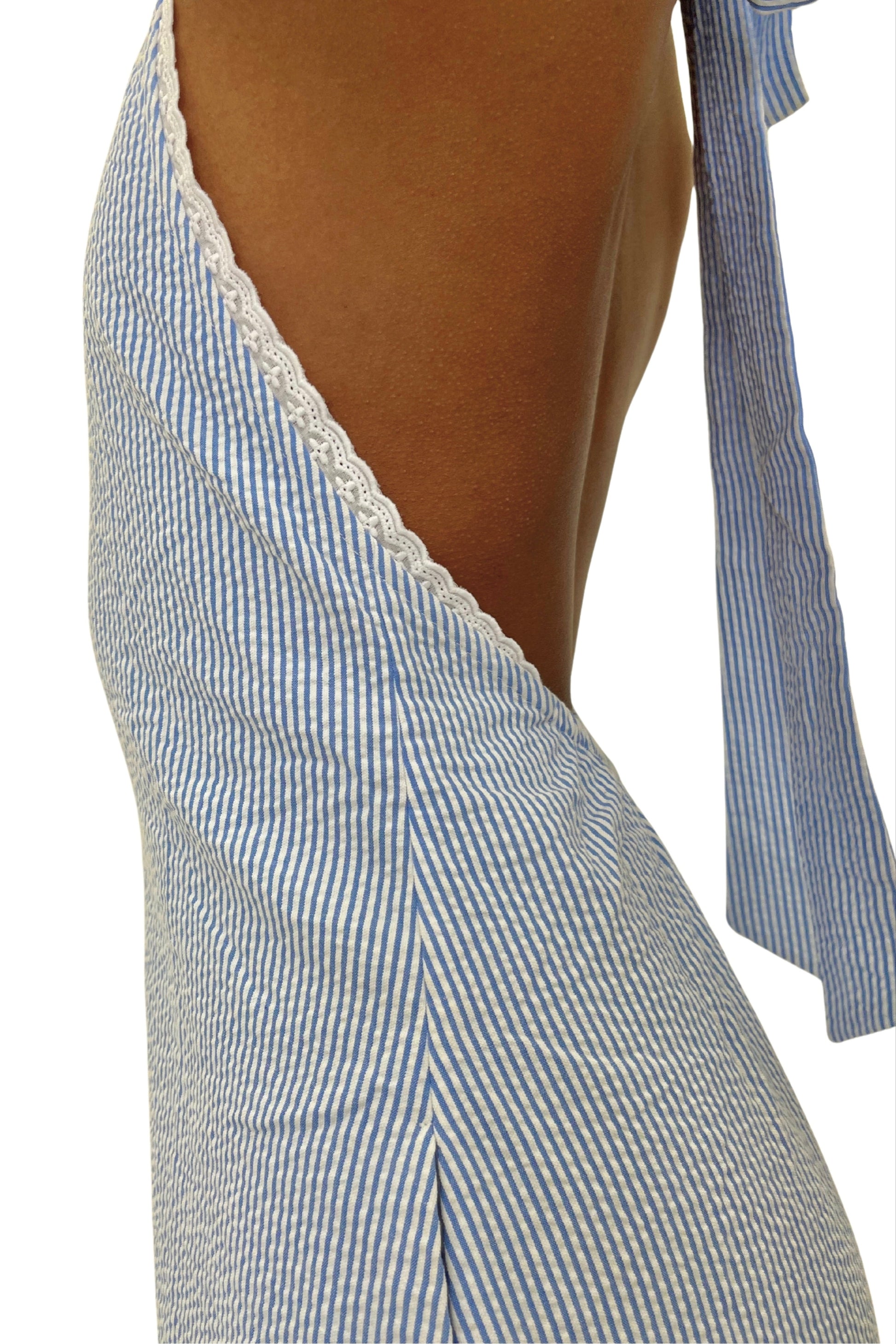 Blue and white striped jumpsuit with lace trim on a white background