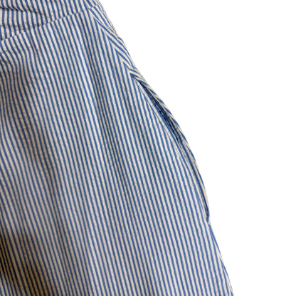 Close-up of a blue and white striped jumpsuit with lace trim on a white background