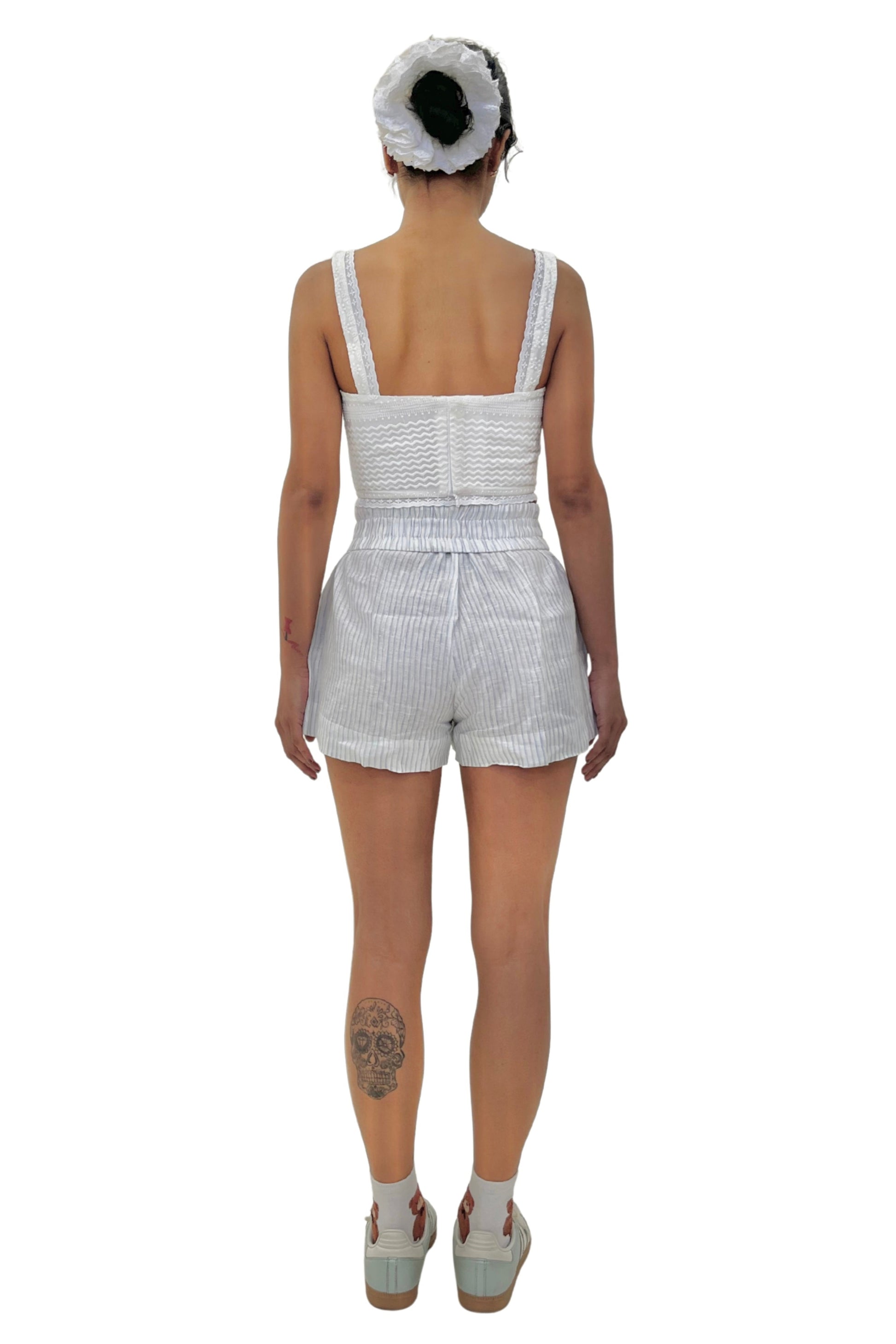 model in white corset and striped linen short