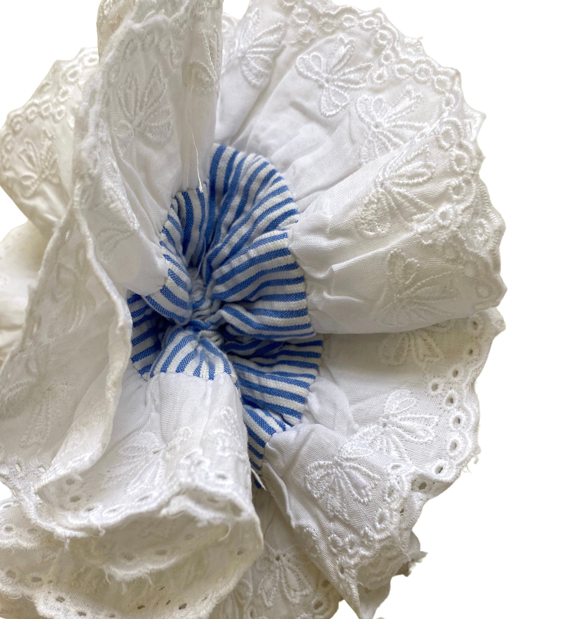 White lace headband with a blue and white striped bow on a white background