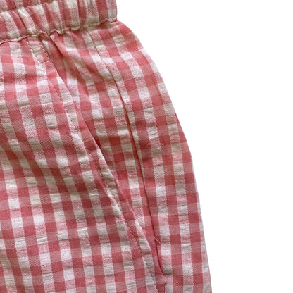 Pink and white checkered fabric on a white background